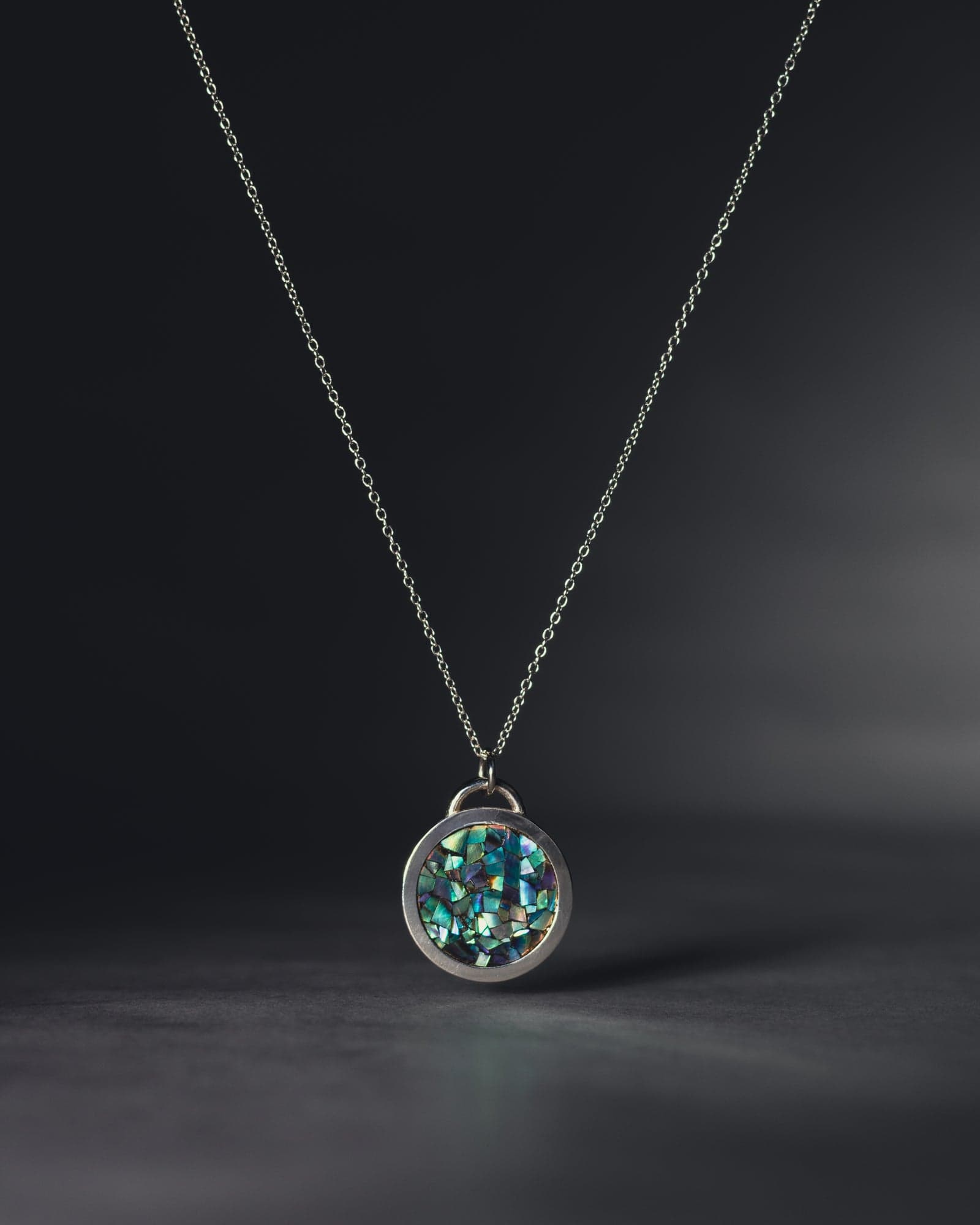 ERNA circle pendant with blue mother-of-pearl mosaic, shot on black